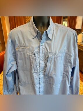Simms long sleeve fishing shirt. Sharp light blue with Embroidered logos. Large
